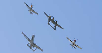 Lockheed P-38J Lightning NX138AM 23 Skidoo, North American P-51D Mustang NL5441V Spam Can, P-51D Mustang NL7715C Wee Willy II, and Fairchild-Republic A-10A Thunderbolt II of the 355th Fighter Wing